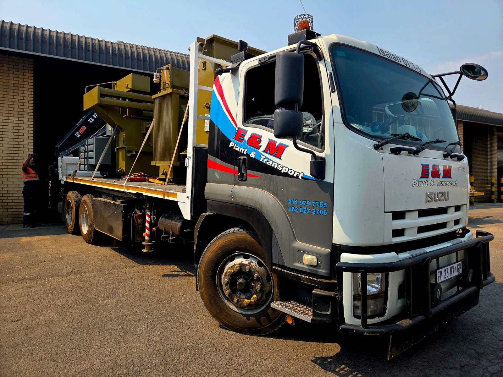 Crane truck lifting a container on site
